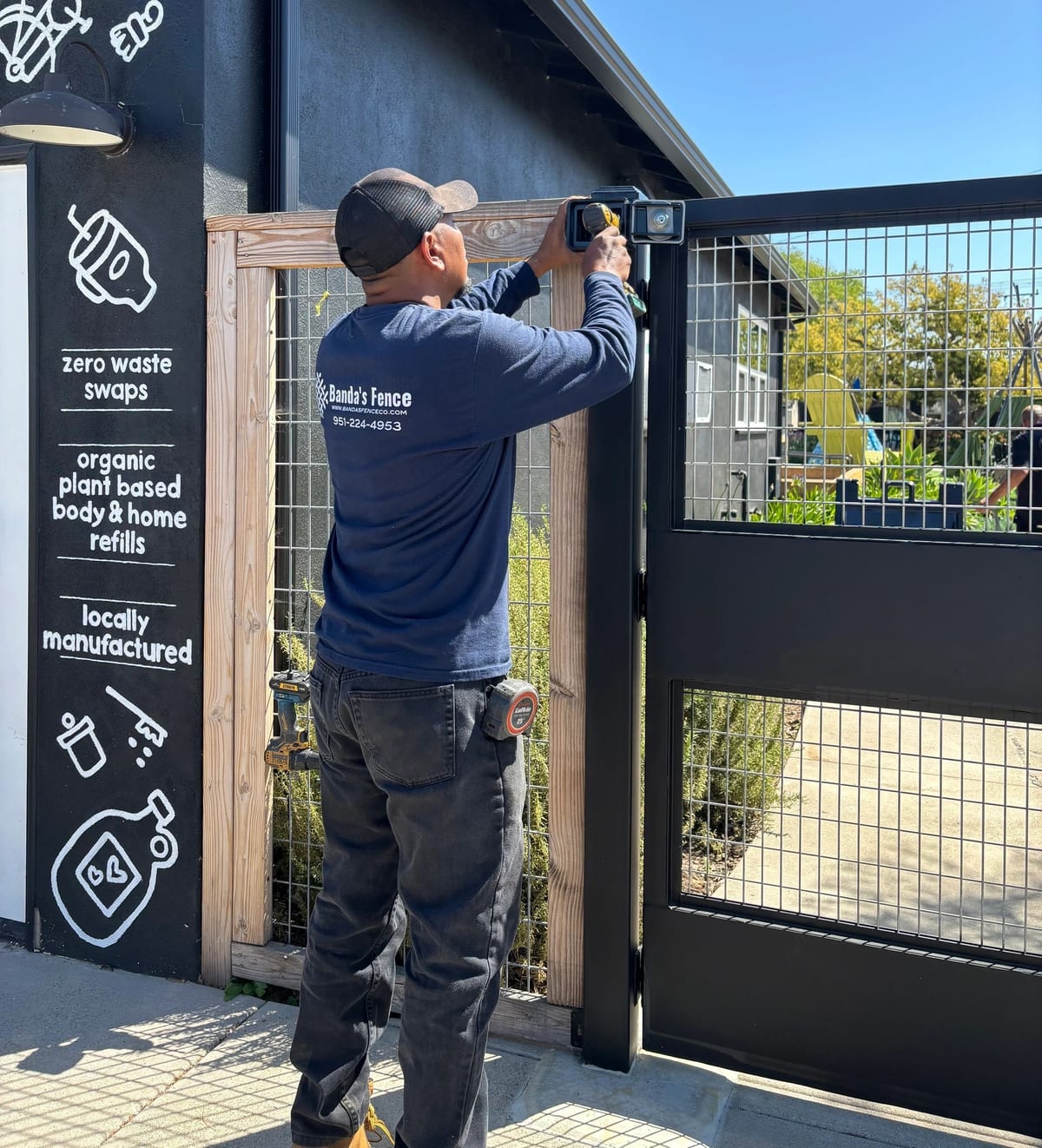 Banda's Fence installing a steel gate latch on a residential fence